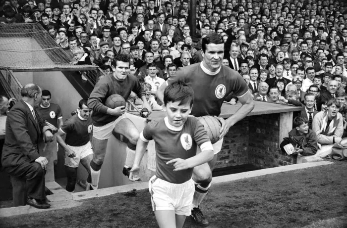 Framed Print : The Liverpool team run onto the pitch with their young mascot before the English league
