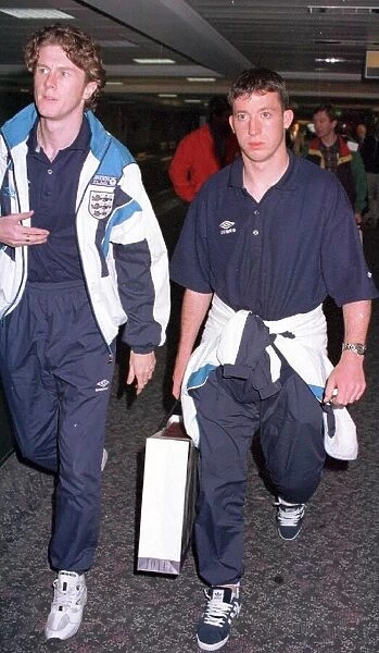 Liverpool teammates Steve McManaman (left) and Robbie Fowler arrive back at Heathrow