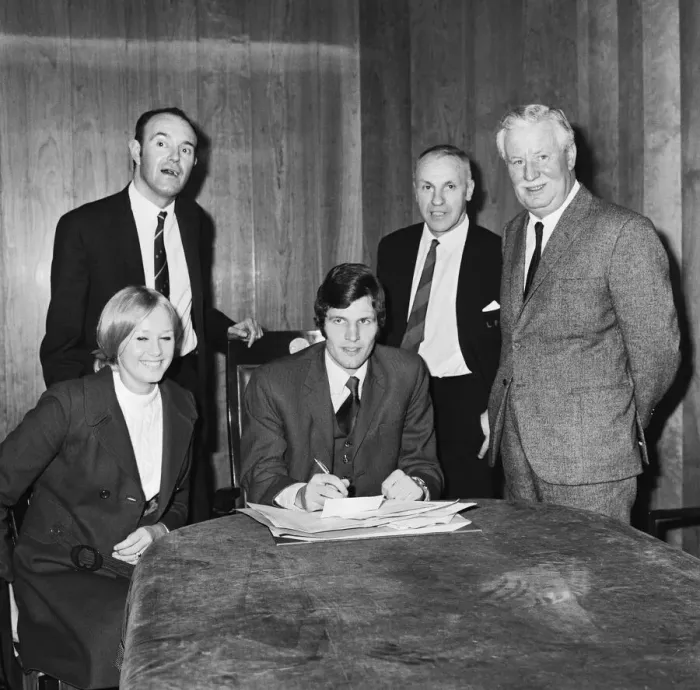 Framed Print : Liverpools new signing John Toshack from Cardiff City signs his contract accompanied Framed Print : Liverpools new signing John Toshack from Cardiff City signs his contract accompanied