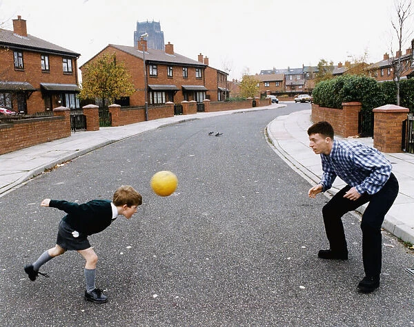 Liverpools young teen sensation Robbie Fowler plays football with six-year old Scott