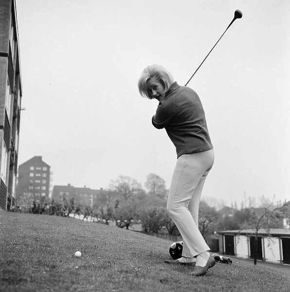 Liz Fraser, English actress, practices her golf swing, April 1967