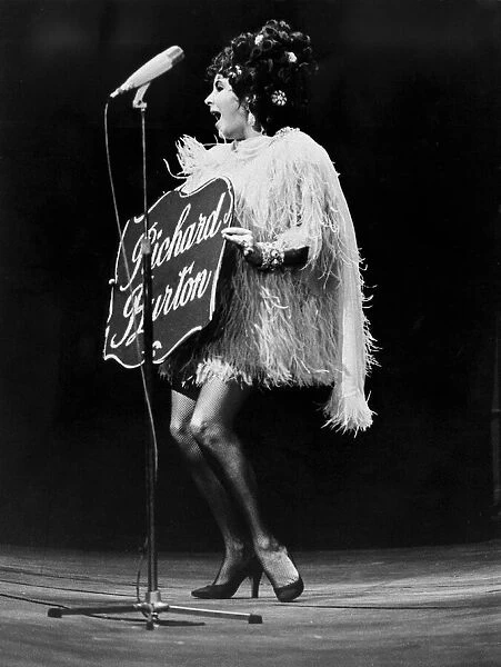 Liz Taylor introduces her husband at a charity show in Paris on the day she became a