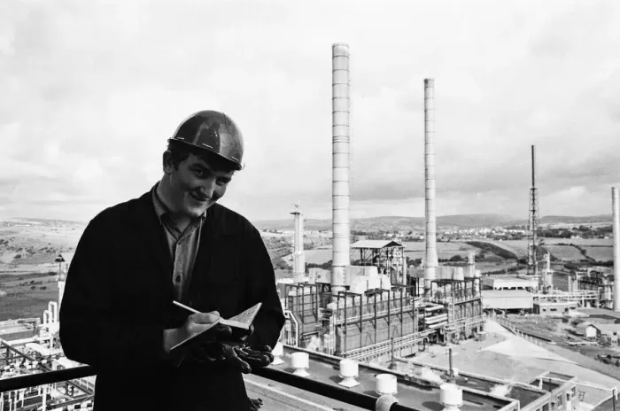 Framed Print : Llandarcy oil refinery. Philip Cole, 17, makes notes and looks out over the oil plant