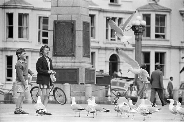 Llandudno, a seaside town in Conwy County Borough, Wales. Children feeding the seagulls