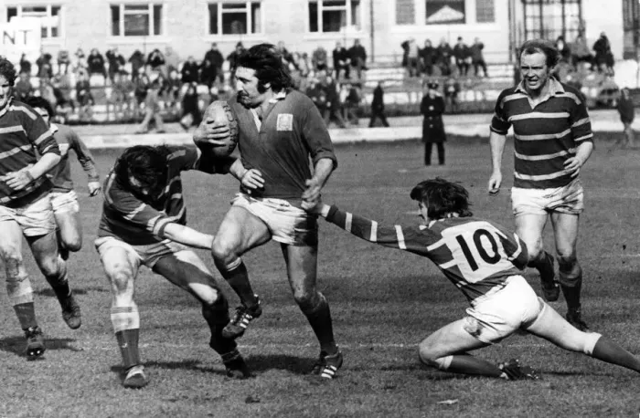 Framed Print : Llaneli forward Tommy David looks quite capable of taking on half the Bridgend team in Framed Print : Llaneli forward Tommy David looks quite capable of taking on half the Bridgend team in