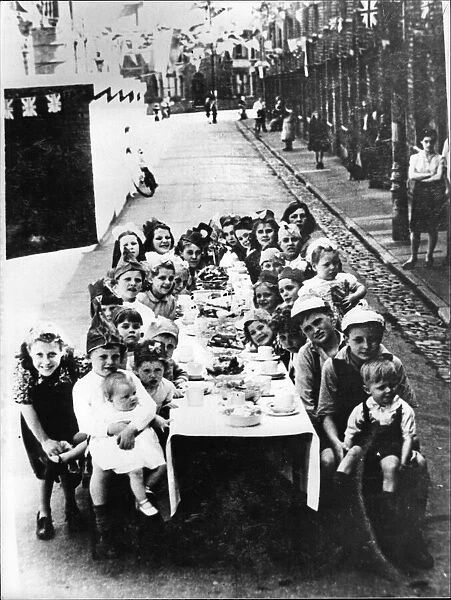 Local children enjoy a VE Day party in Beam Street, Barton Hill, Bristol. 8th May 1945