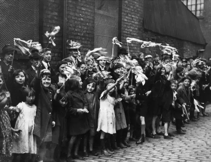 Framed Print : Local children wave their flags and cheer in Craven Street during the visit of the Duke