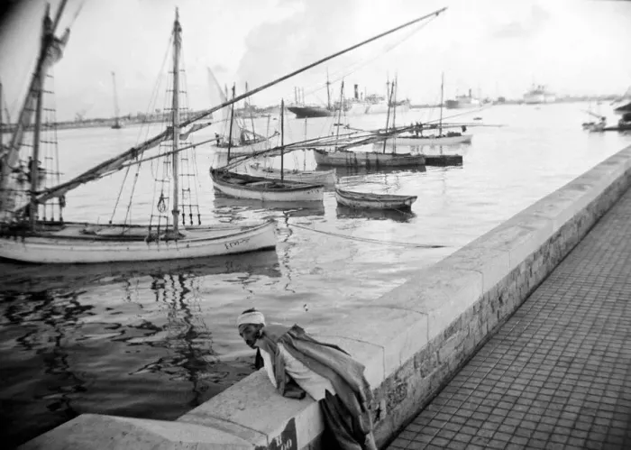 Framed Print : Local man looking at the boats in the harbour in Somaliland Circa 1935 Framed Print : Local man looking at the boats in the harbour in Somaliland Circa 1935