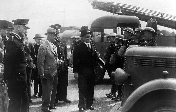 A local mayor inspecting an auxiliary fire fighting crew. Circa 1940