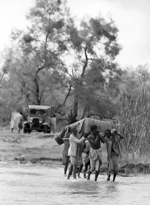 Framed Print : Local men of Abyssinia carring heavy objects across a river Circa 1935 People