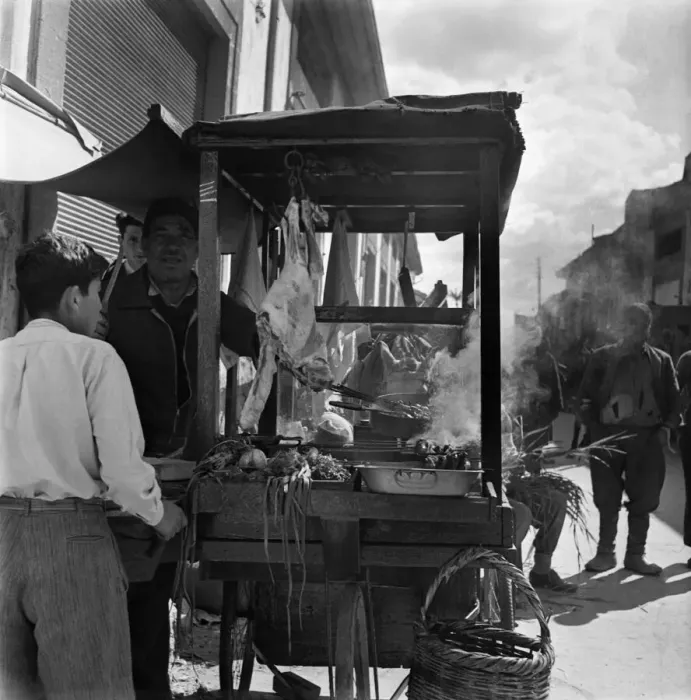 Framed Print : Local people buying meat at a market stall in a town in Cyprus Framed Print : Local people buying meat at a market stall in a town in Cyprus