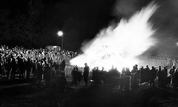 Local residents gather around the bonfire at Clairville Common