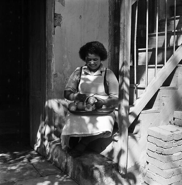 A local woman peeling oranges in a town in Cyprus. March 1952 C1296