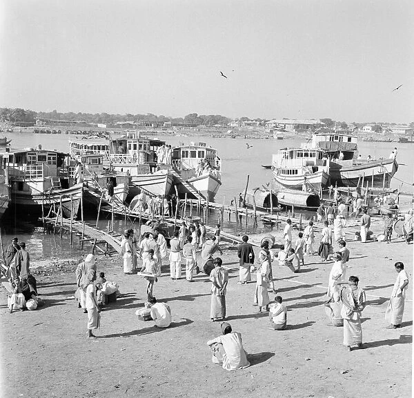 Locals wait to board ferryboats that crowd the harbour in Dacca, Bangladesh