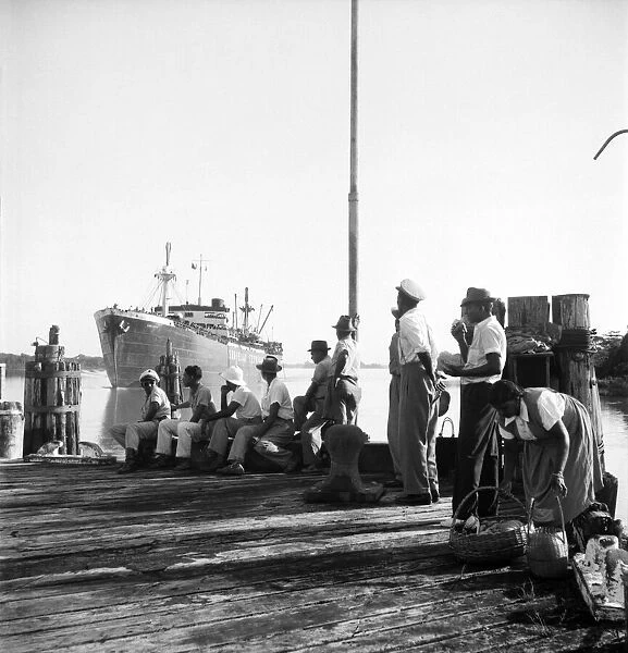 Locals watch the approach of the troopship carrying the Argyle