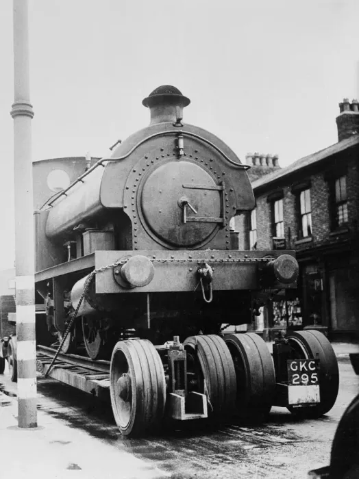 Framed Print : A locomotive train is drawn through the streets of Stretford on the way to the repair