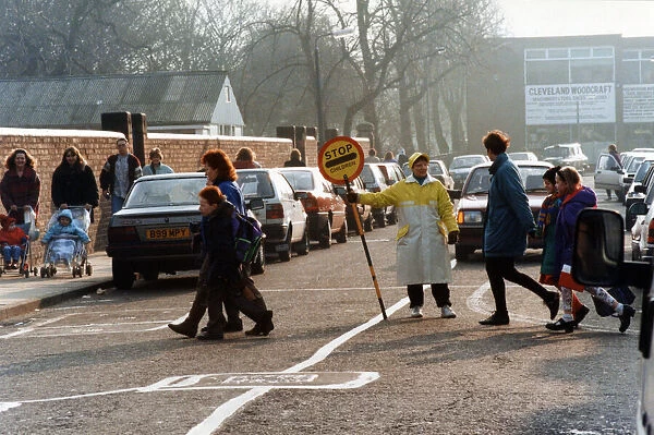 Lollipop lady Susan Hall escorts children across Crescent Road, Worcester Street Crossing