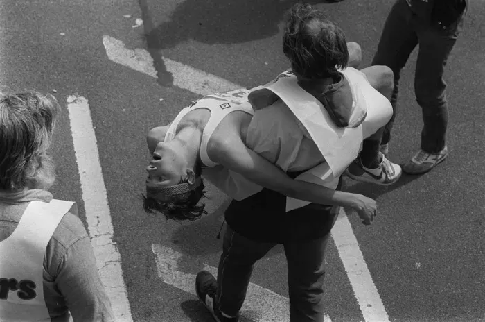 Framed Print : London Marathon one man carrying another in his arms after the race 1984 Framed Print : London Marathon one man carrying another in his arms after the race 1984
