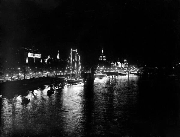 London by night - Boats illuminated by night along the River Thames 1951