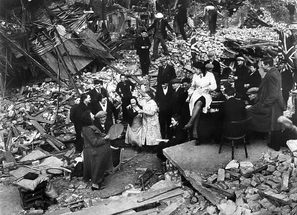 London residents of a bombed out street hold a street party amongst the ruins of their