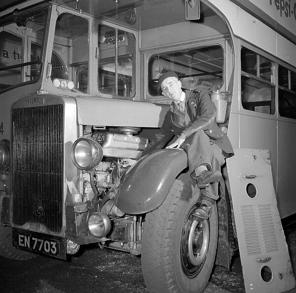 London Transport mechanic seen here checking the engine of a Leyland bus