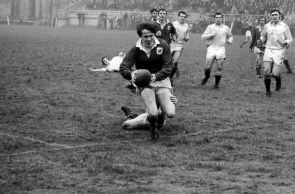 London Welsh v. Swansea. R. H. Phillips goes over the line to score despite a last ditch