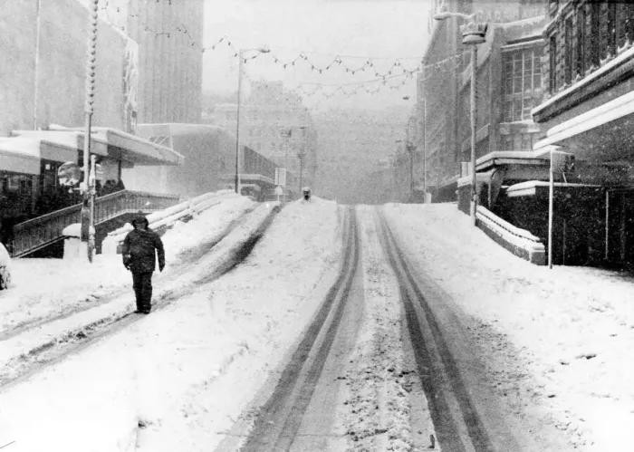 Framed Print : A lone pedestrian walks down Corporation Street near Lewiss Store. Birmingham
