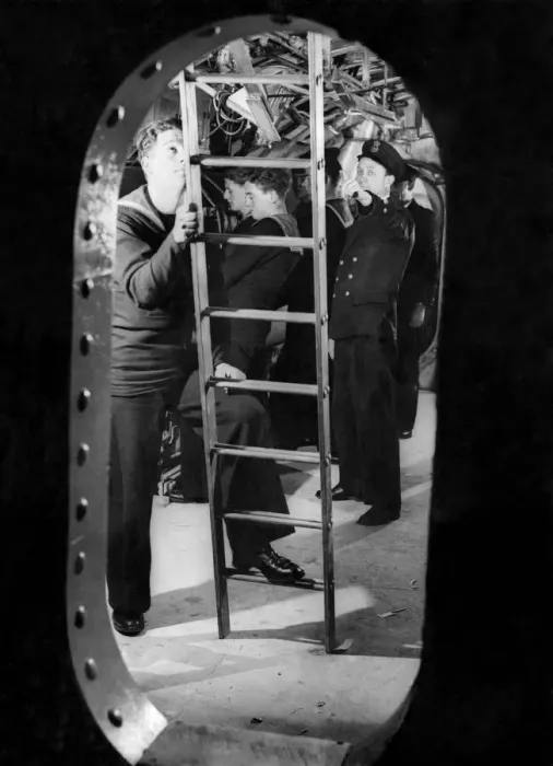 Framed Print : Looking through the bulkhead at the submarine trainees in the torpedo room with the crew Framed Print : Looking through the bulkhead at the submarine trainees in the torpedo room with the crew