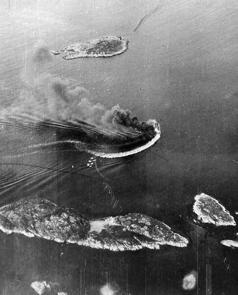 Looking down on Lodingen Harbour, Norway as an enemy aircraft tender circles out of
