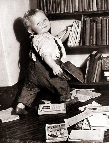 It looks like this little boy would love to become a librarian! Circa 1950