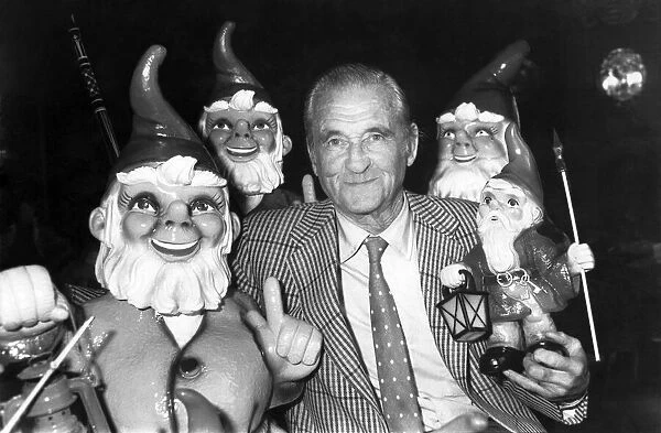 Lord Bath at his Longleat home earlier today (Sat) together with a collection of gnomes