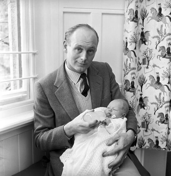 Lord Montagu of Beaulieu with his newborn son Ralph Montagu giving him his first feed at