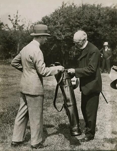 Lord Riddell presents a bag of golf clubs to the Duke of York made by many famous players