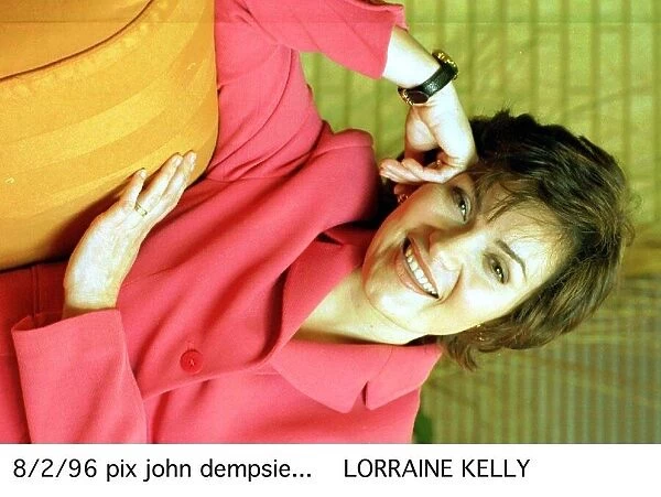 Lorraine Kelly TV Presenter wearing pink jacket and black strap watch A©mirrorpix