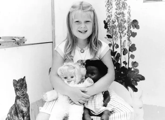 Framed Print : Louise Brown Test tube Girl holding dolls on her sith birthday July 1984