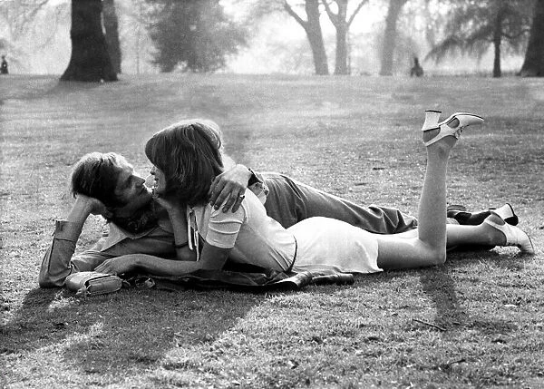 Love and romance A couple lie entwined on a mans coat in the park, May 1971