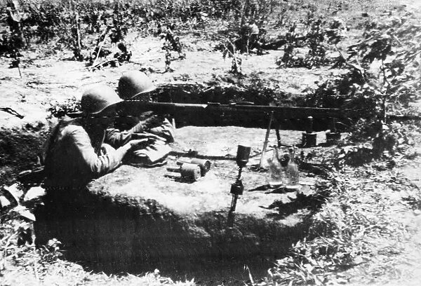 A low platform with surrounding trench dug into the soil with two soldiers of the Soviet