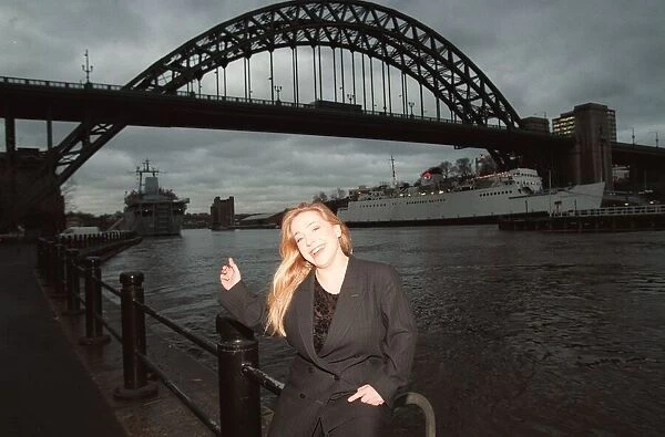 Lowri Turner tv presenter and journalist standing beside the Tyne Bridge Newcastle