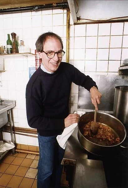 Loyd Grossman TV Presenter of Master Chef in his own kitchen trying out his own cooking