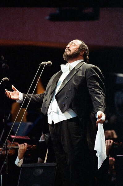 Luciano Pavarotti, the Italian operatic tenor, singing at an outdoor concert in