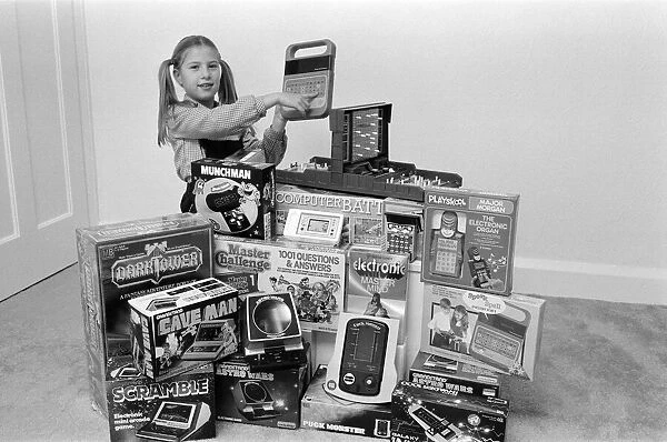 A lucky child surrounded by a selection of electronic games available in the shops this