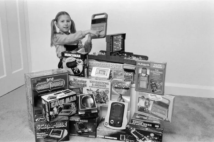 Framed Print : A lucky child surrounded by a selection of electronic games available in the shops this Framed Print : A lucky child surrounded by a selection of electronic games available in the shops this
