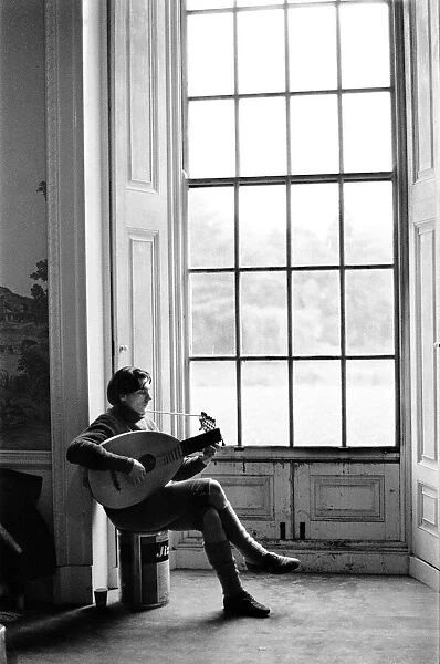 A lute player rehearses during a break in filming of Peter Halls '