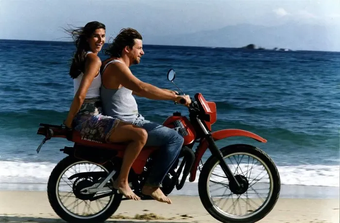 Framed Print : Lynn Wales with Andreas taverna owner on back of motorbike on beach Mykonos Framed Print : Lynn Wales with Andreas taverna owner on back of motorbike on beach Mykonos