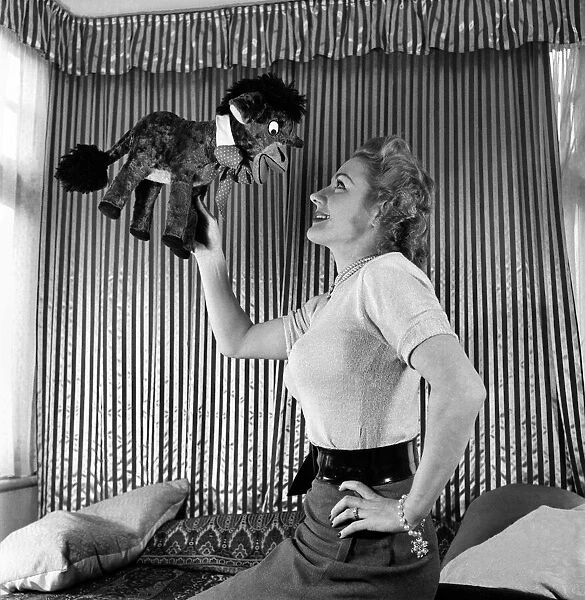 Lynne Breton. Woman with stuffed toy donkey. October 1952 C4870-002