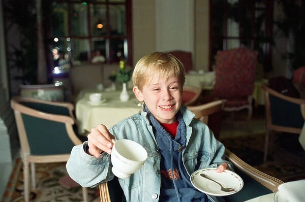 Macaulay Culkin sips his tea as he toasts his membership of he million-dollar-a movie
