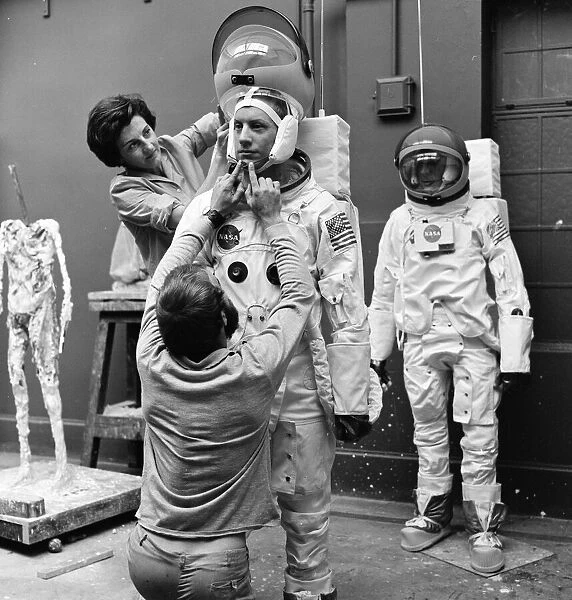 Madame Tussauds staff put the finishing touches to waxwork models of astronauts Neil