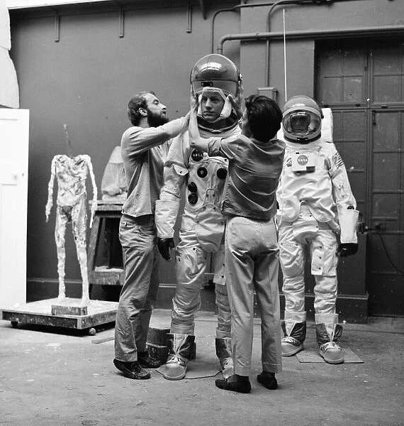 Madame Tussauds staff put the finishing touches to waxwork models of astronauts Neil