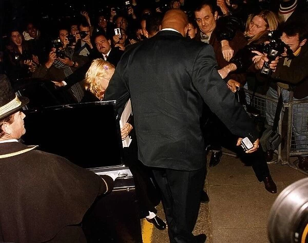 Madonna actress & singer getting out of a car with her bodyguard The Wall