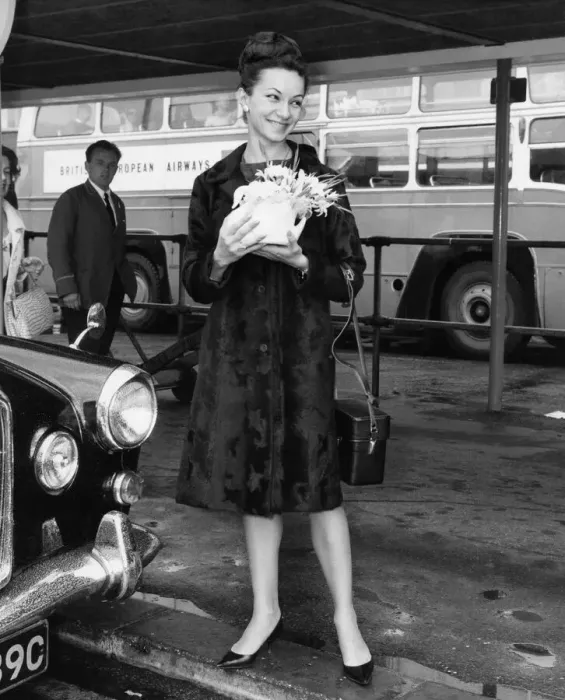 Framed Print : Magdalena Popa holding flowers waiting for a lift. June 1966 P005931 Framed Print : Magdalena Popa holding flowers waiting for a lift. June 1966 P005931